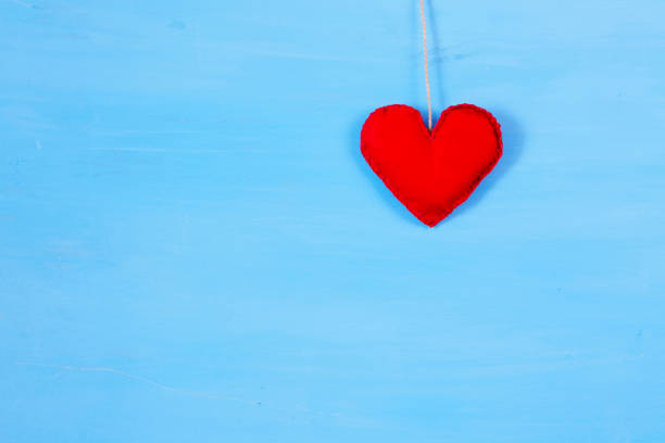 istock Red heart on string. Romantic love vintage wooden background 918154588