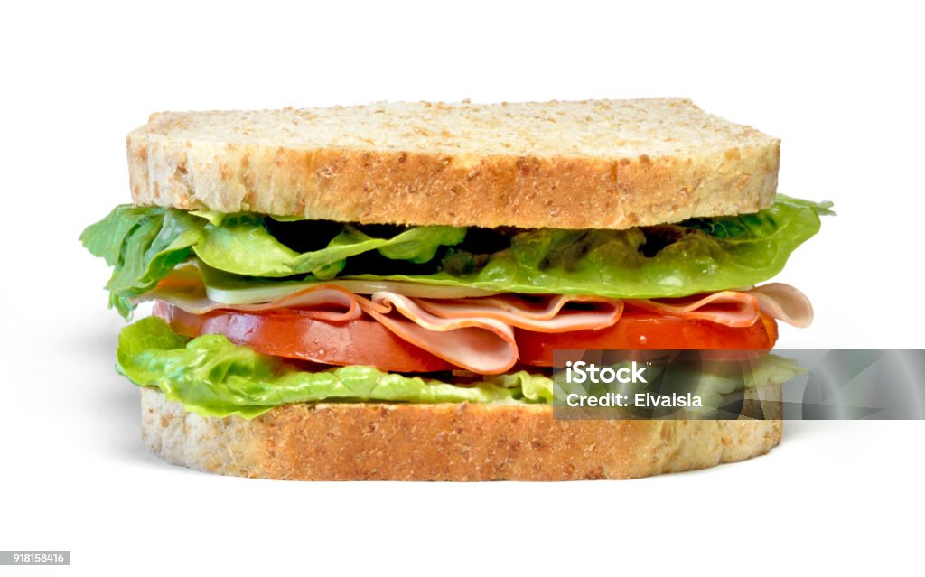 Delicious ham and cheese sandwich Delicious ham and cheese sandwich, isolated on white background. Gourmet toast or sandwich with lettuce, tomato, chess and turkey. Whole grain sandwich, healthy eating. Sandwich Stock Photo