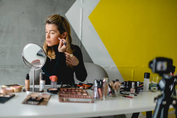 istock Young woman putting make up on her face 918162402