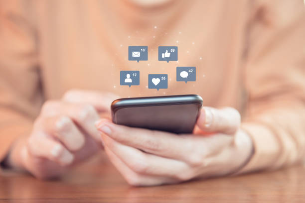 istock Woman hands using mobile smartphone with icon social media and social network. 918163210