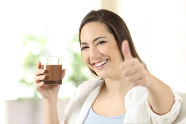 istock Woman holding a cocoa drink looking at camera 918166264