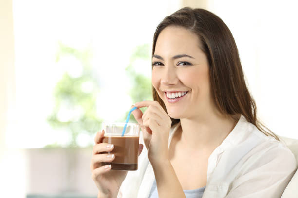 istock Woman drinking cocoa shake looking at camera 918166382