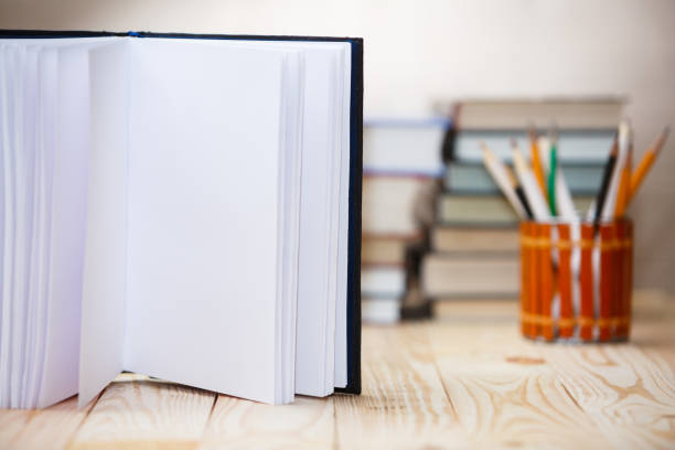 istock Open book on wood desk with blurred focus for background. 918166566