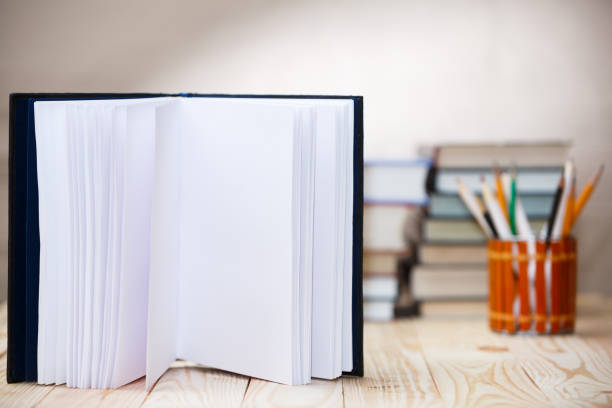 istock Open book on wood desk with blurred focus for background. 918169070