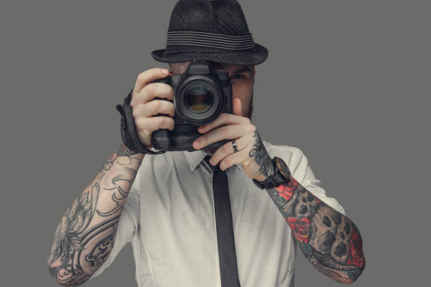 istock A man with dslr isolated on grey background. 918170236