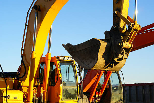 istock Hydraulic excavator at work. Shovel bucket against blue sky 91817028