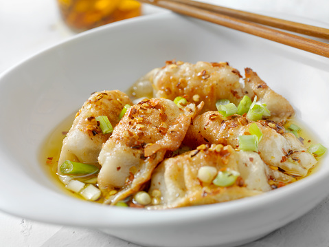 Asian Pork Dumplings in Chili Oil with Green Onions