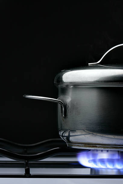 istock Pot on a lit gas stove with black background 91817438