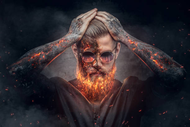 Demonic male with burning beard and arms. Demonic male with burning beard and arms in fire sparks. hell photos stock pictures, royalty-free photos & images