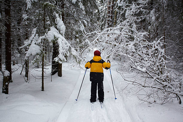 A young couple got out of the city into the woods to go skiing.