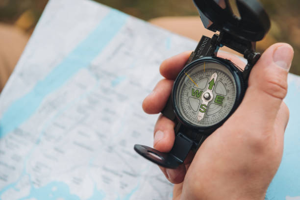 istock tourist holding compass in hand 918183060