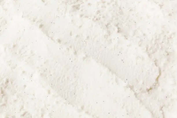 Close-up of vanilla bean ice cream texture with scoop marks