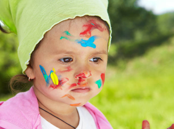 istock Little girl draws paints 918184706
