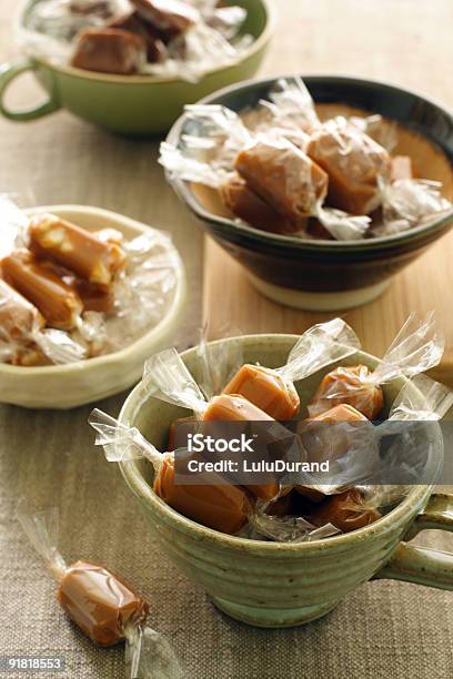 Four Pottery Bowls All Containing Wrapped Caramel Candies Stock Photo - Download Image Now
