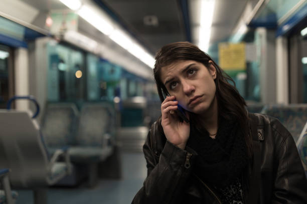 Sad depressive woman in train going home from work.Tired exhausted looking young lady getting away with train ride.Bored female person during commute time.Public transportation user