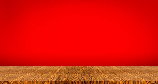 istock wooden table top with color red background 918187274