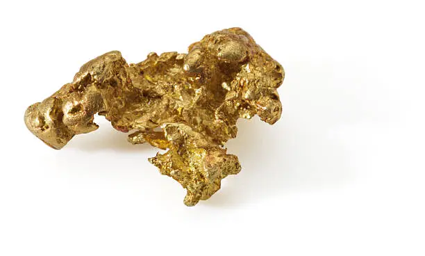 Photo of Small gold nugget on white background