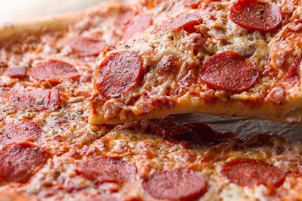 istock Pepperoni pizza with one slice cut off 918199298