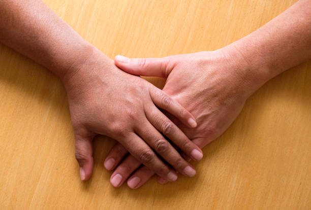 Wedding couple holding hands. Bride and groom holding his hands