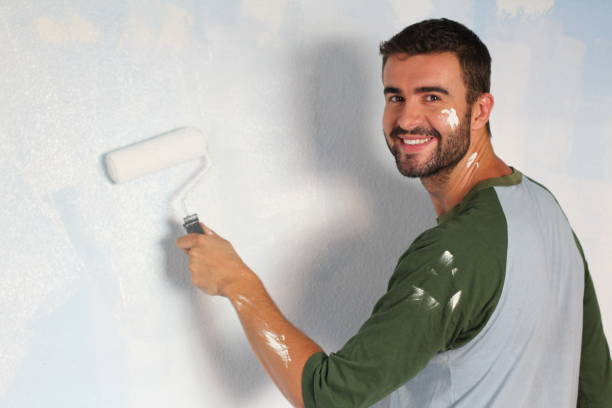 istock Hot man painting a wall isolated 918201416