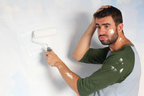 istock Stressed out male painting his home 918201598