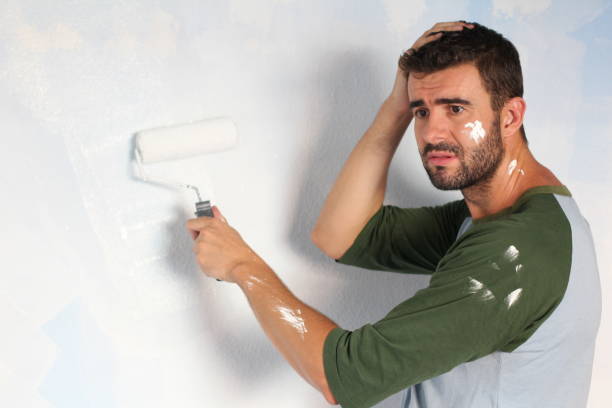 istock Stressed out male painting his home 918201616