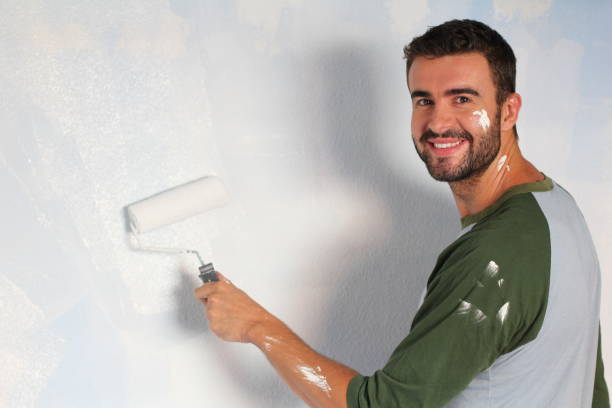 istock Cute man paining his new home 918201626