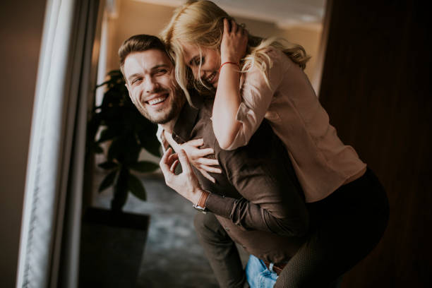 istock Young man carrying young woman on his back 918201770