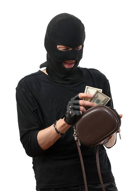 istock Robber takes money from stolen handbag. 91820472