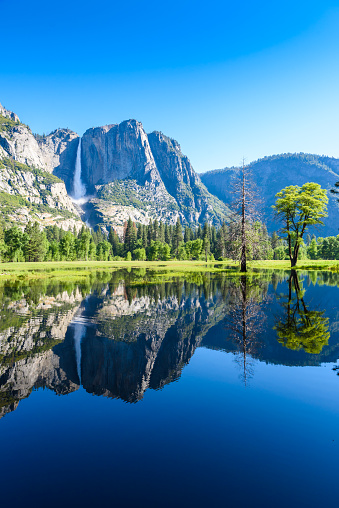 Yosemite National Park - Reflection in Merced River of Yosemite waterfalls and beautiful mountain landscape, California, USA - travel destination
