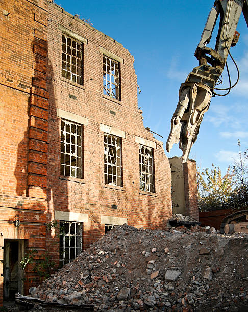 Collapsed wall and shattered bricks at construction site. High quality photo