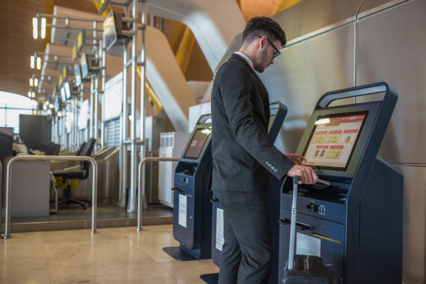 istock Young business man doing self check in a machine at the airport 918212856