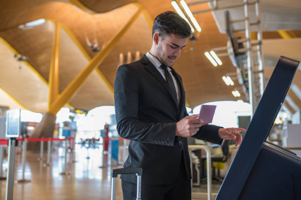 istock Young business man doing self check in a machine at the airport 918213026