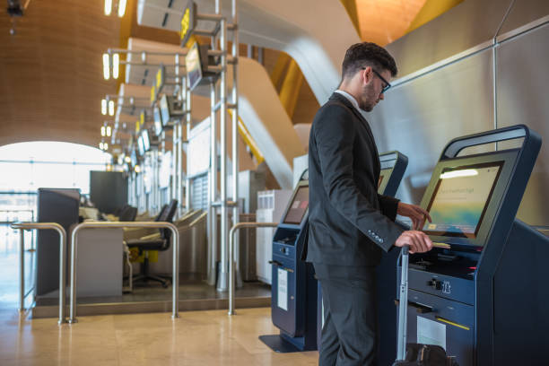 istock Young business man doing self check in a machine at the airport 918215152