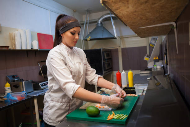 istock a girl prepares food sushi 918215326
