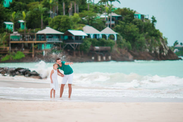 istock Father and his kid at tropical beach walking together 918227440