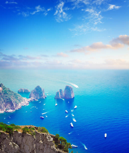 Famous Faraglioni cliffs and Tyrrhenian Sea waters, Capri island, Italy