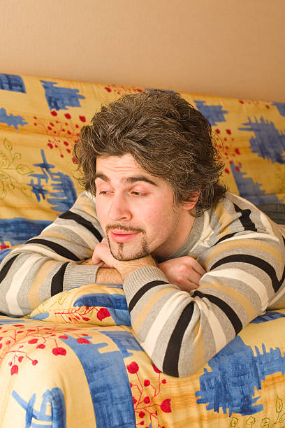 istock Young handsome male on colourful sofa 91822828