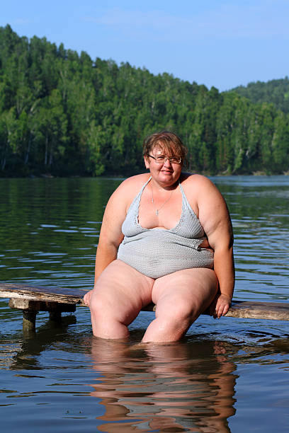 istock overweight woman sitting on stage 91823360