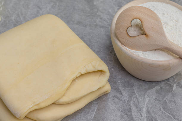 istock Puff pastry with flour and heart spoon 918234104
