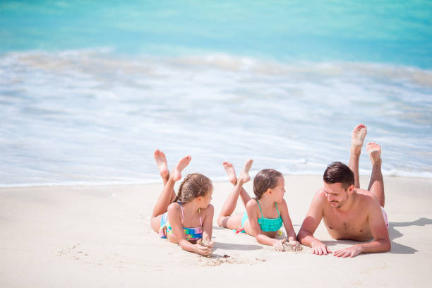 istock Father and kids enjoying beach summer tropical vacation 918237730