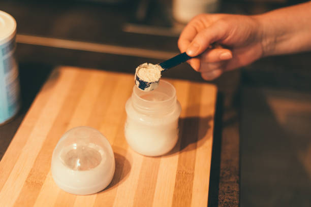 istock Mother making baby formula in milk bottle 918239068