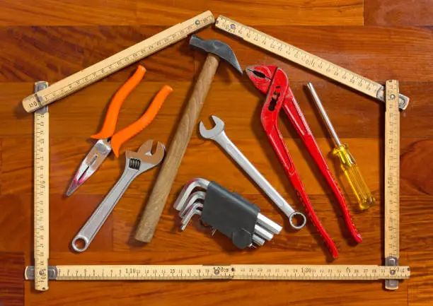 House shape folded measuring stick containing work tools