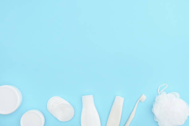 istock top view of plastic containers and bottles with cream, sponge, toothpaste and toothbrush, isolated on blue 918245420