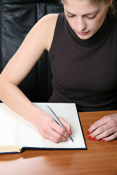 istock Beautiful woman writing in office 91824697