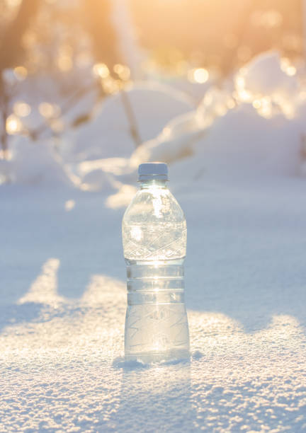 water bottle in snow stock photo