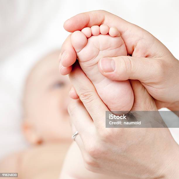 Two Hands Massaging A Babys Foot Stock Photo - Download Image Now - Child, Group Of People, Massage Therapist