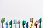 istock row of different toothbrushes, on white with copy space 918248412