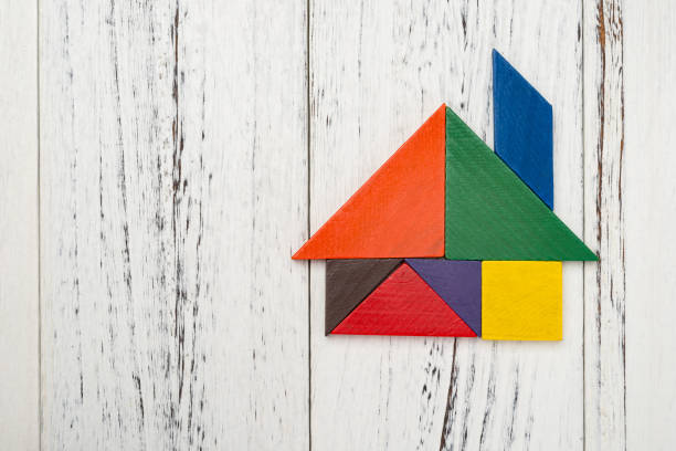 istock wooden tangram shaped like a house with copy space 918248474