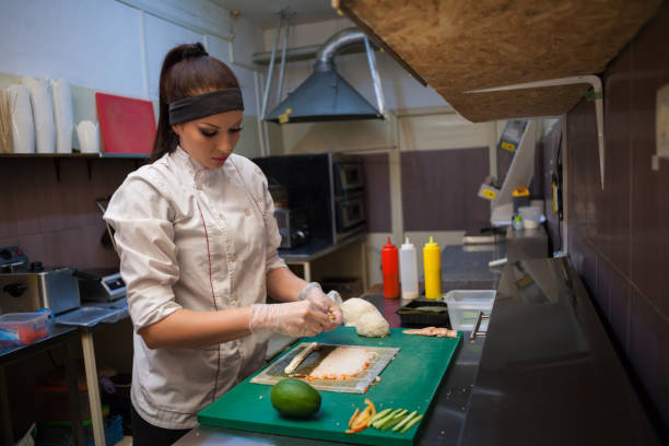 a girl prepares food sushi